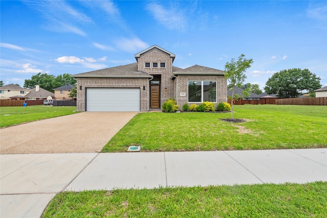 view of front facade with a garage and a front lawn