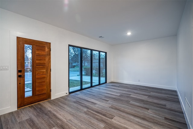 empty room with dark hardwood / wood-style flooring