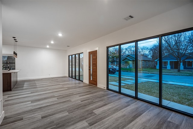 interior space with sink and hardwood / wood-style flooring