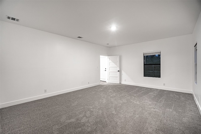 empty room featuring dark carpet