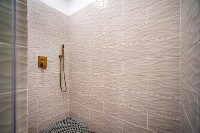 bathroom with tiled shower