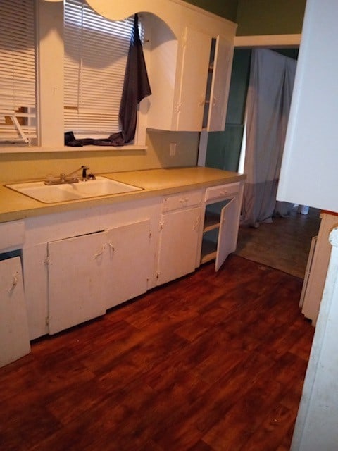 kitchen featuring white cabinets, dark hardwood / wood-style floors, and sink