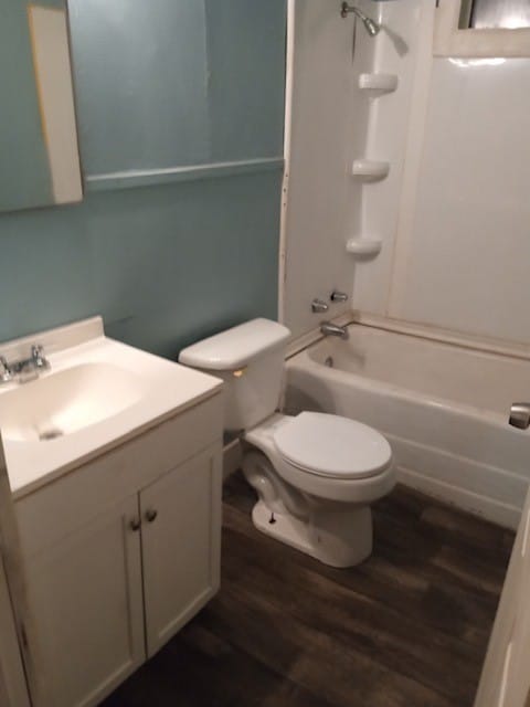 full bathroom with toilet, shower / washtub combination, wood-type flooring, and large vanity