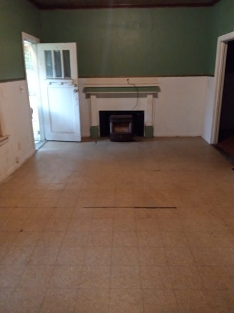 unfurnished living room with light tile flooring