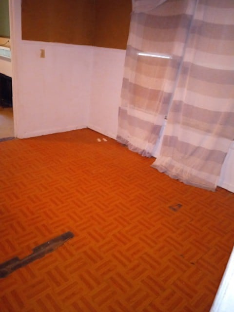 spare room with dark parquet flooring