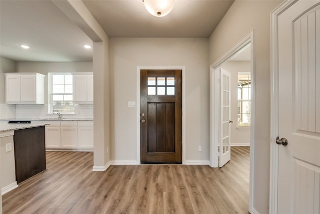 entrance foyer with sink and light hardwood / wood-style flooring