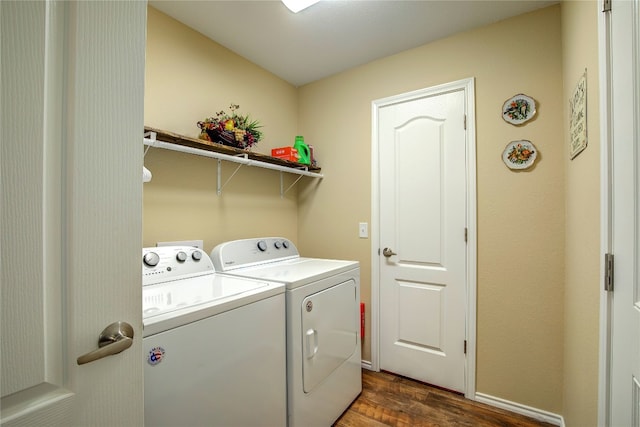 laundry room with washing machine and clothes dryer and dark hardwood / wood-style flooring