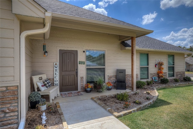 entrance to property featuring a lawn