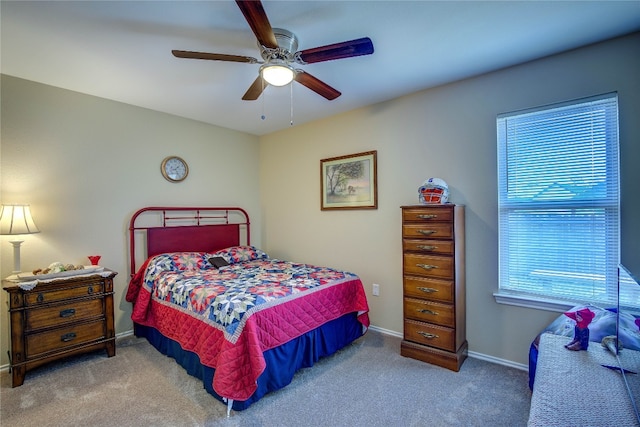 bedroom with ceiling fan and dark colored carpet