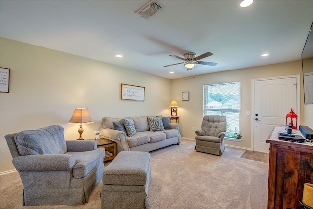 living room featuring light carpet and ceiling fan