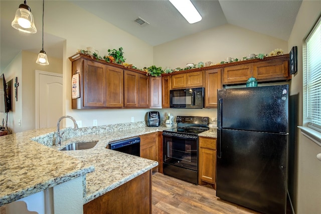 kitchen with sink, hanging light fixtures, light hardwood / wood-style floors, vaulted ceiling, and black appliances