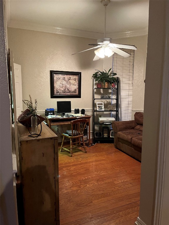 home office featuring ceiling fan, hardwood / wood-style floors, and ornamental molding