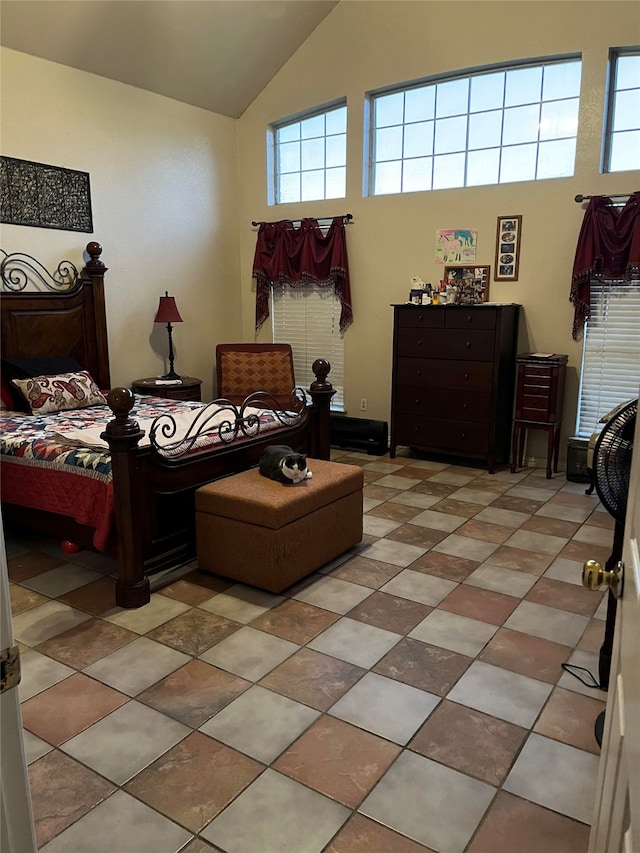 bedroom with vaulted ceiling and multiple windows