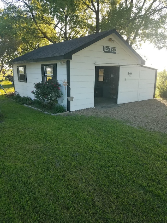 view of outbuilding with a yard