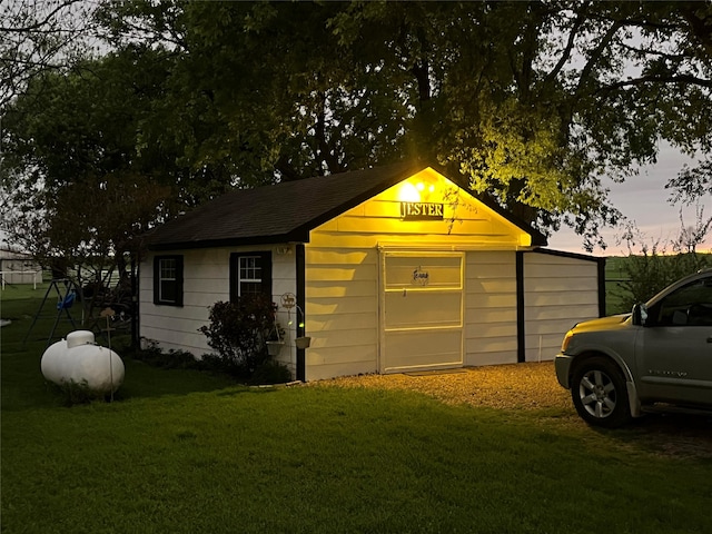 outdoor structure at dusk with a lawn