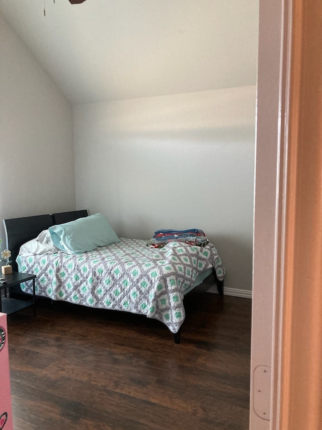 bedroom with lofted ceiling, ceiling fan, and dark wood-type flooring