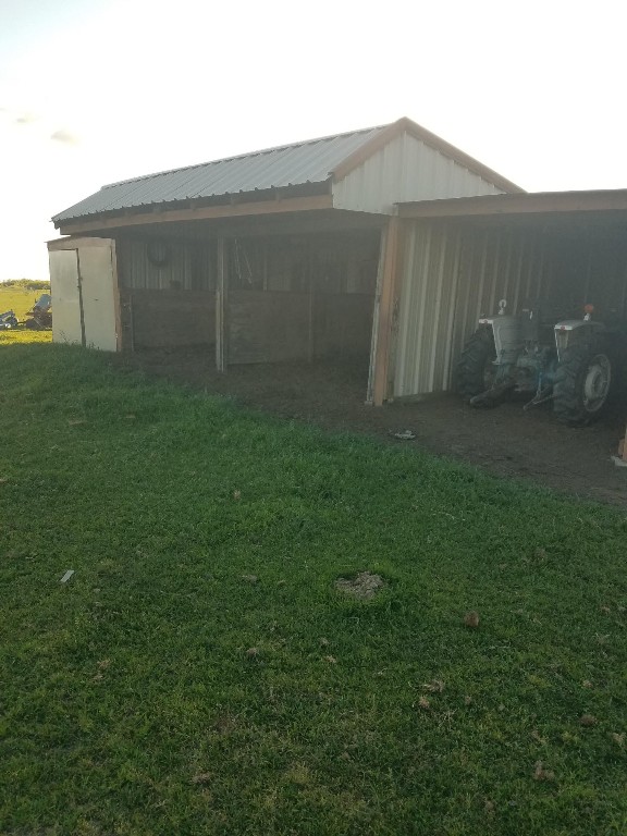 view of outdoor structure with a lawn