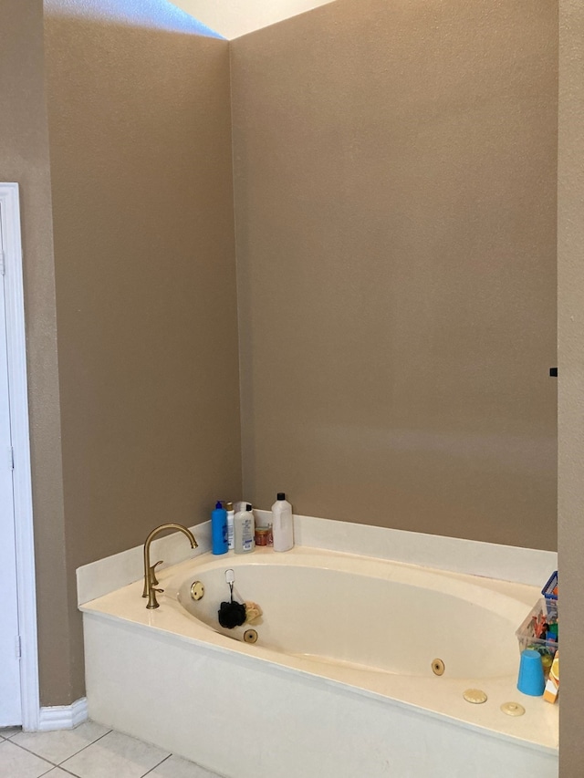 bathroom featuring tile patterned flooring and a tub to relax in