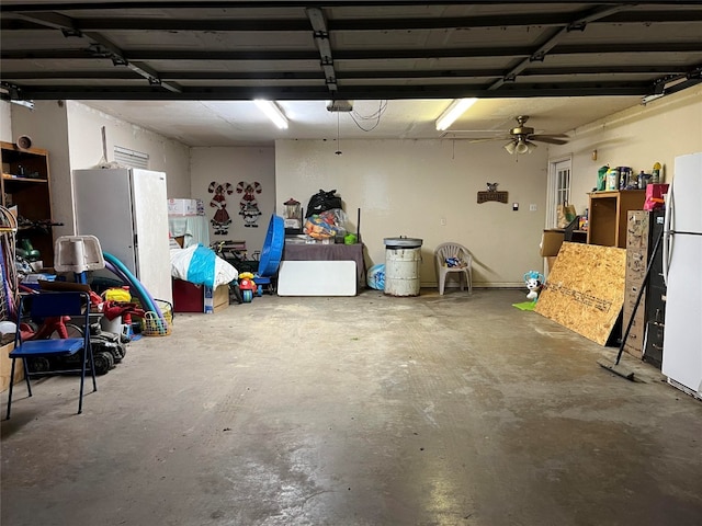 garage with ceiling fan, white fridge, a garage door opener, and fridge