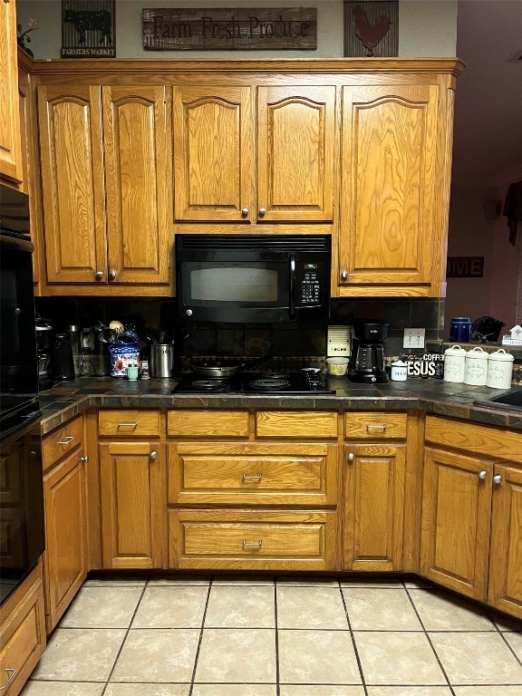 kitchen with light tile patterned floors and black appliances