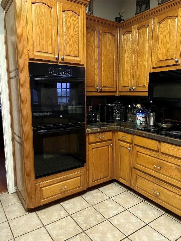 kitchen featuring light tile patterned floors and black appliances