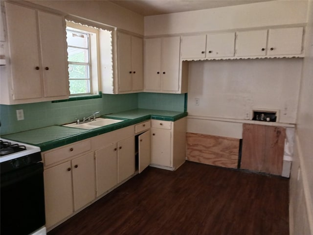 kitchen with dark hardwood / wood-style floors, sink, electric range, white cabinets, and tasteful backsplash