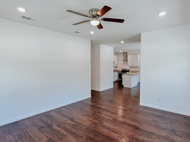 unfurnished room featuring dark hardwood / wood-style flooring and ceiling fan