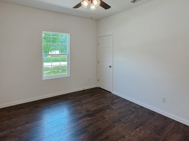 empty room with dark hardwood / wood-style floors and ceiling fan