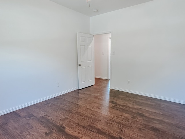 spare room with dark hardwood / wood-style flooring