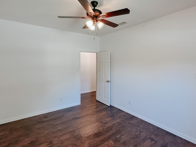 spare room featuring ceiling fan and dark hardwood / wood-style floors