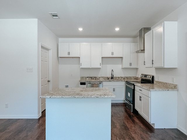 kitchen with dark hardwood / wood-style floors, wall chimney exhaust hood, white cabinetry, and range with electric stovetop