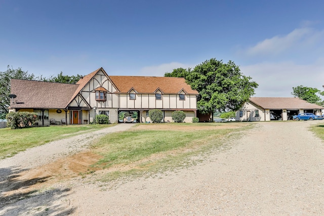 tudor house featuring a front yard