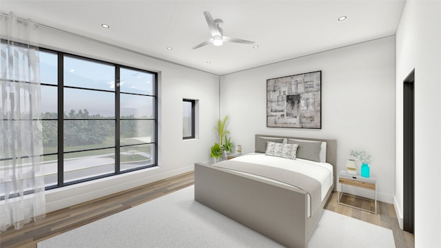 bedroom with light hardwood / wood-style floors and ceiling fan