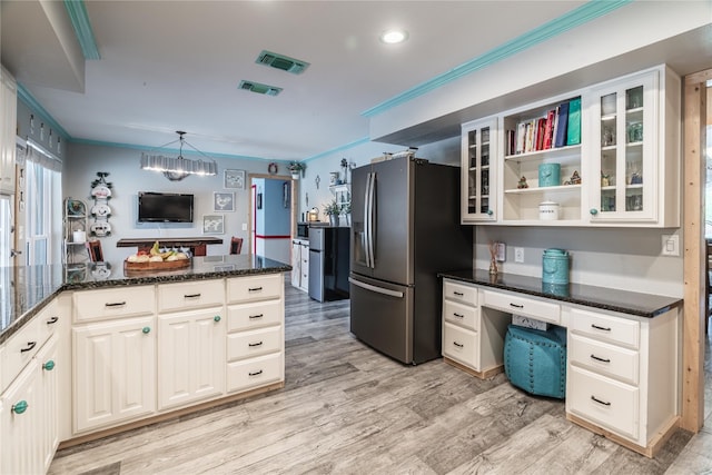 kitchen featuring a chandelier, light hardwood / wood-style floors, decorative light fixtures, and stainless steel refrigerator with ice dispenser