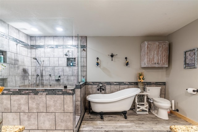 bathroom featuring tile walls, tiled shower, toilet, and hardwood / wood-style flooring