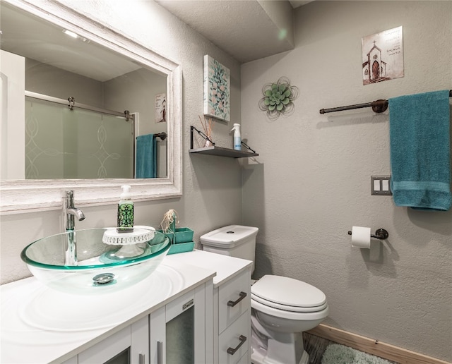 bathroom with vanity with extensive cabinet space and toilet