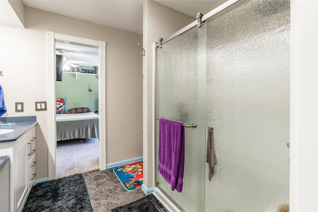 bathroom featuring ceiling fan, tile flooring, a shower with shower door, and vanity