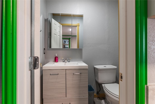 bathroom featuring toilet and vanity