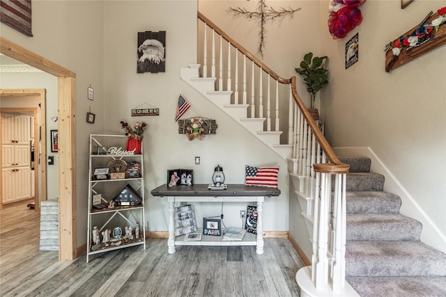 staircase with hardwood / wood-style floors