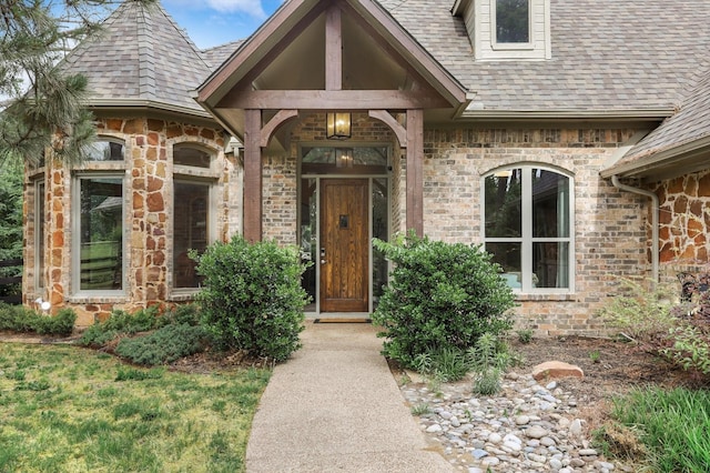 property entrance with brick siding and roof with shingles