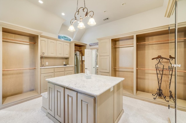 interior space with lofted ceiling, decorative light fixtures, light colored carpet, and a kitchen island