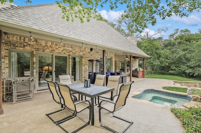 view of patio / terrace featuring a pool with hot tub