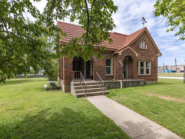 tudor house featuring a front lawn