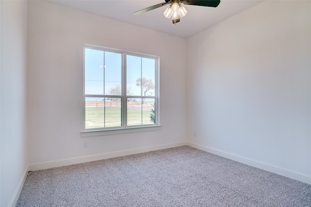 carpeted spare room with ceiling fan