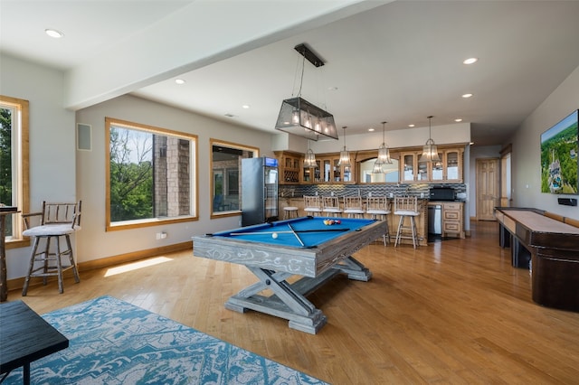 playroom featuring billiards, a healthy amount of sunlight, and light hardwood / wood-style flooring