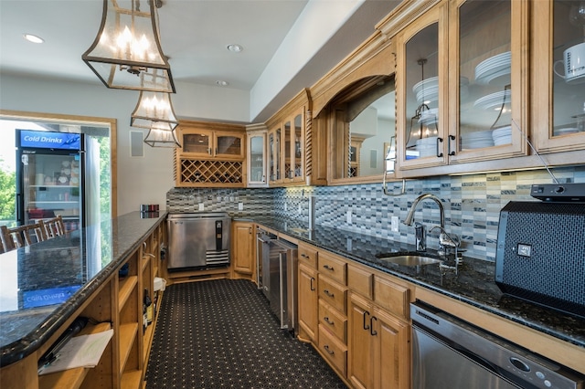 kitchen with hanging light fixtures, backsplash, dark tile floors, sink, and stainless steel dishwasher