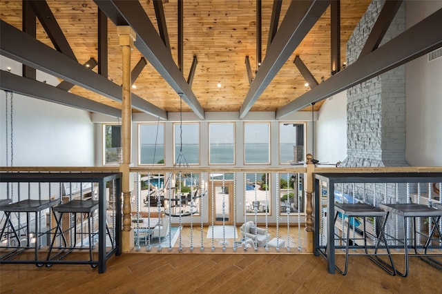 interior space featuring wooden ceiling, high vaulted ceiling, wood-type flooring, and beamed ceiling