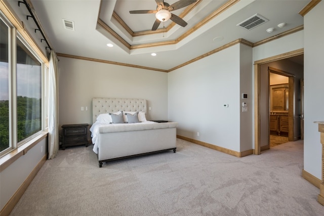 bedroom with ceiling fan, light colored carpet, ornamental molding, and a tray ceiling