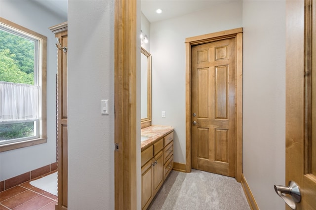 bathroom with oversized vanity and a healthy amount of sunlight