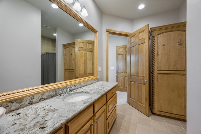 bathroom with tile flooring and vanity